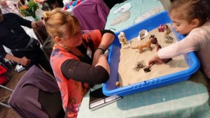 a child processing in the sandtray